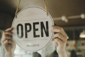 Small business grants Queensland. Owner opening store.